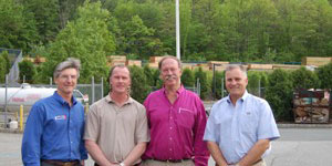 (standing from left to right are John P. Misko, Jr and John Phelan (Lumber 1), and Henry Kuiken and Douglas R. Kuiken (Kuiken Brothers Company, Inc.))